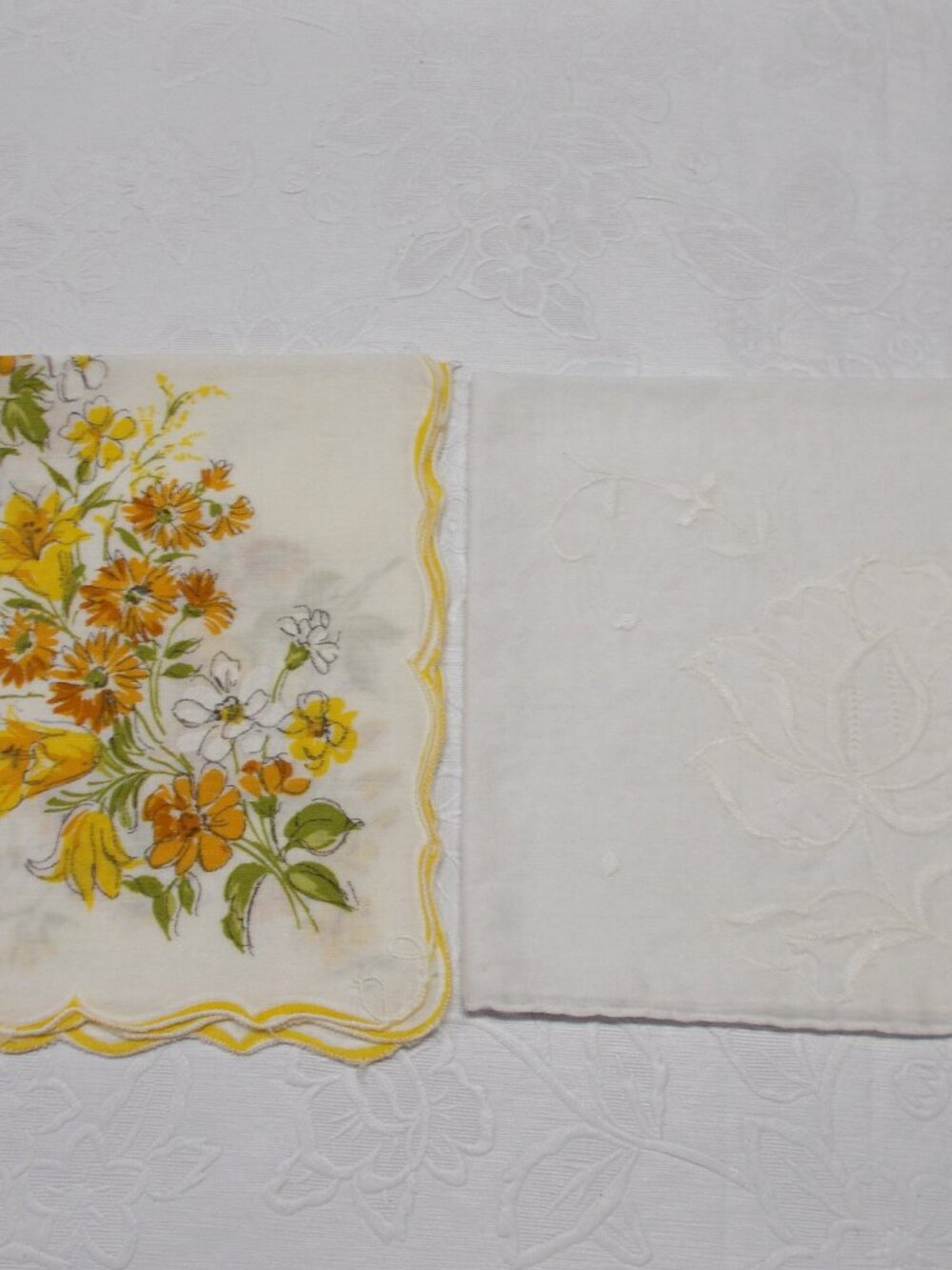 Two women's vintage handkerchiefs, one white, one beige with flowers